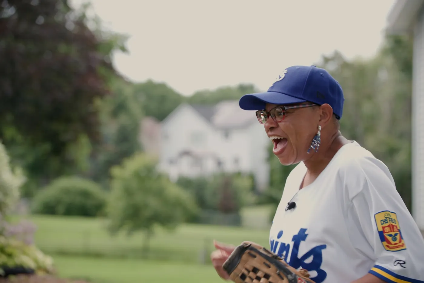 Sheletta in a St. Paul Saints jersey, laughing at the ballpark.